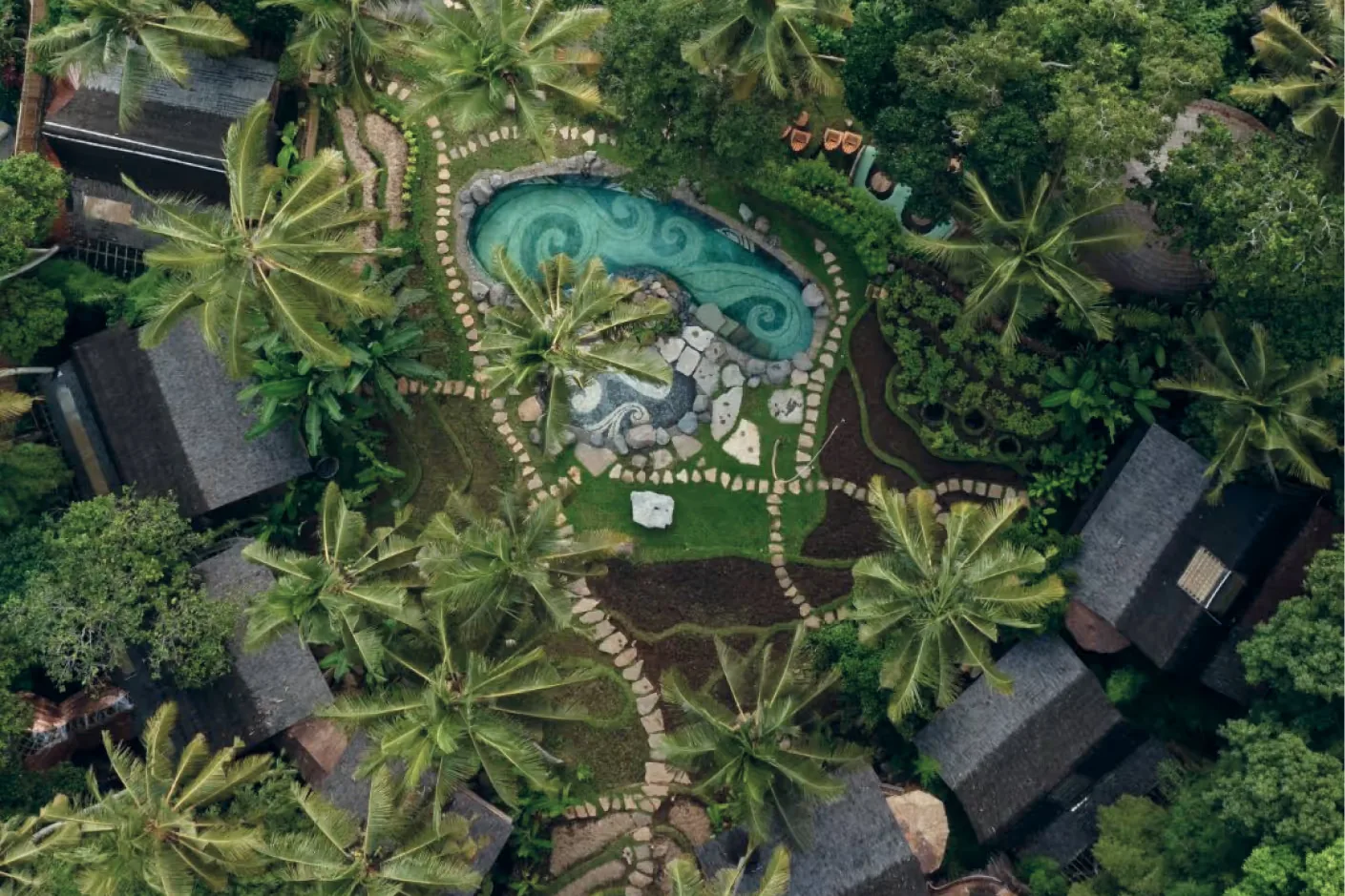 The lodge from above, the pool among the trees