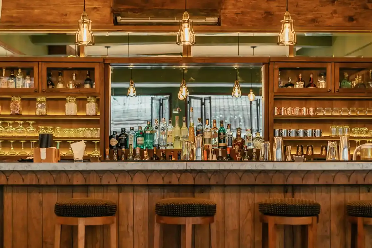 The bar counter and its shelves of bottles