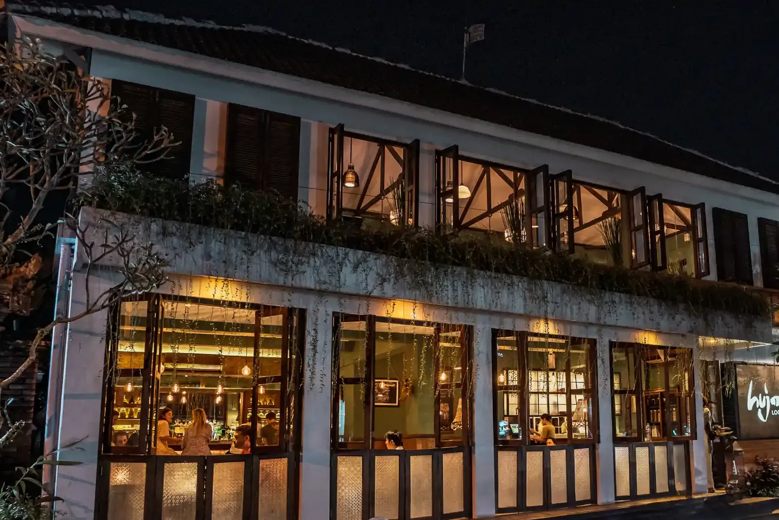 Hujan Locale’s frontage at night, on Jalan Sri Wedari