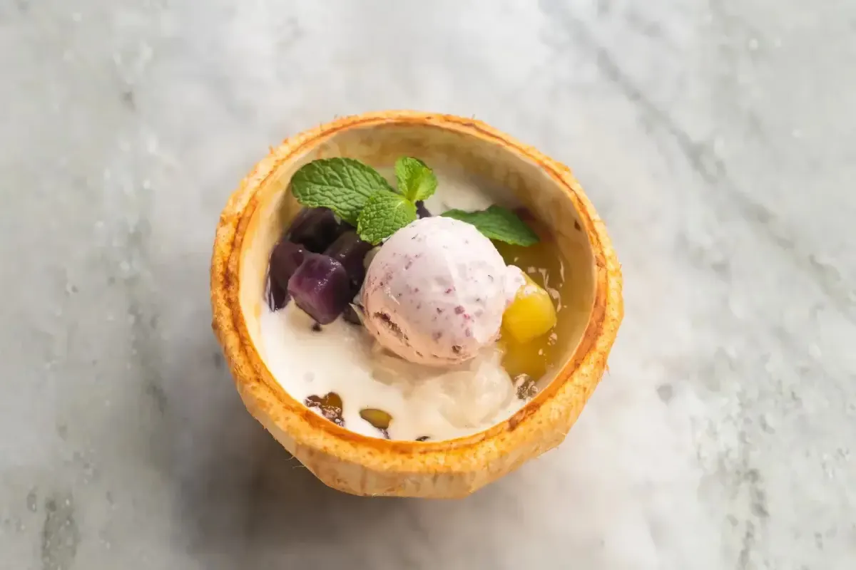 Bubur ubi served in half a coconut