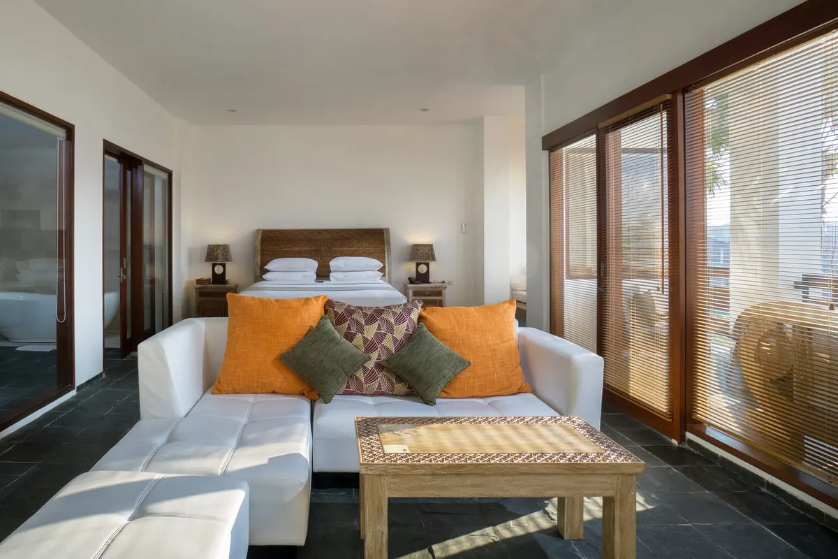 The Suite Room, sofa and bed facing the glass doors
