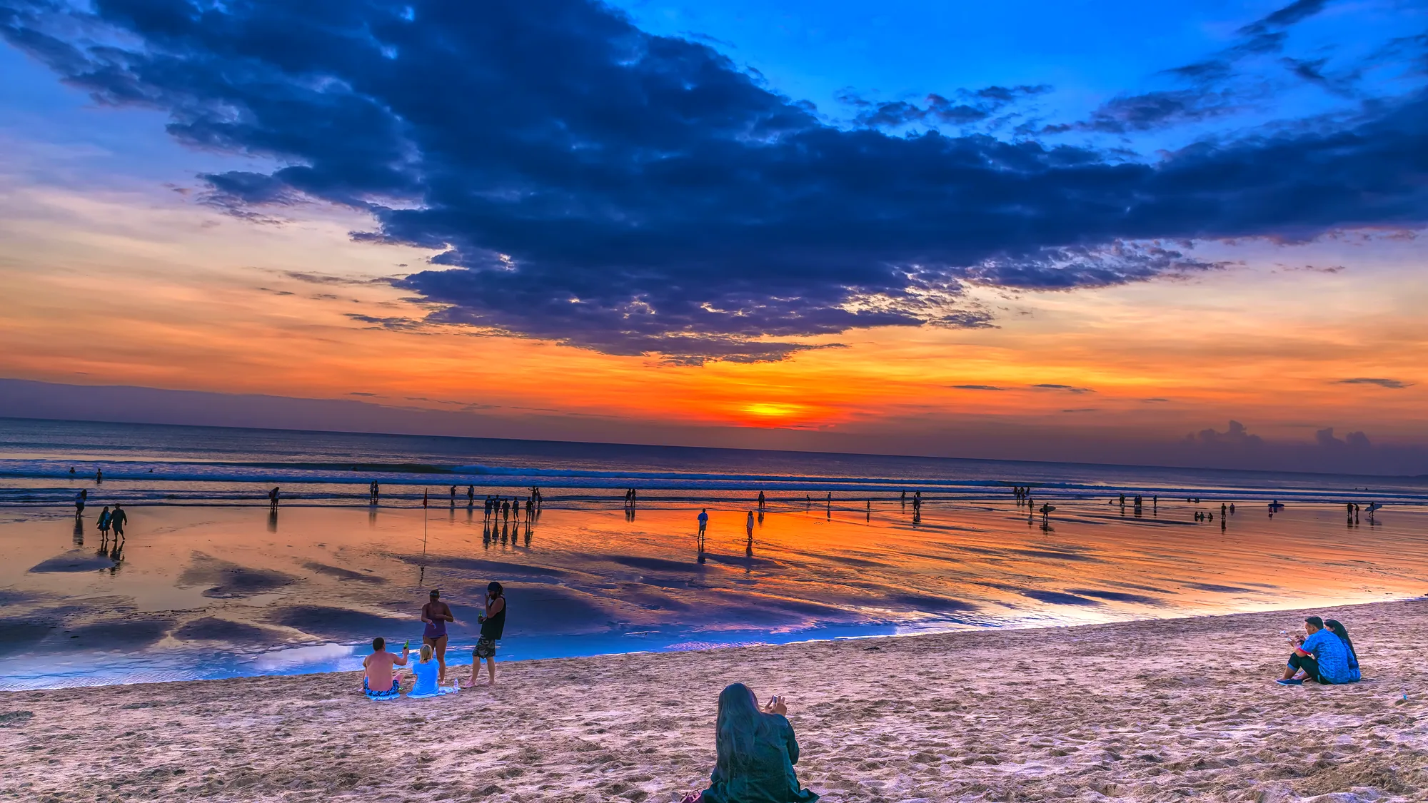 Sunset on Kuta beach, fishing boats offshore