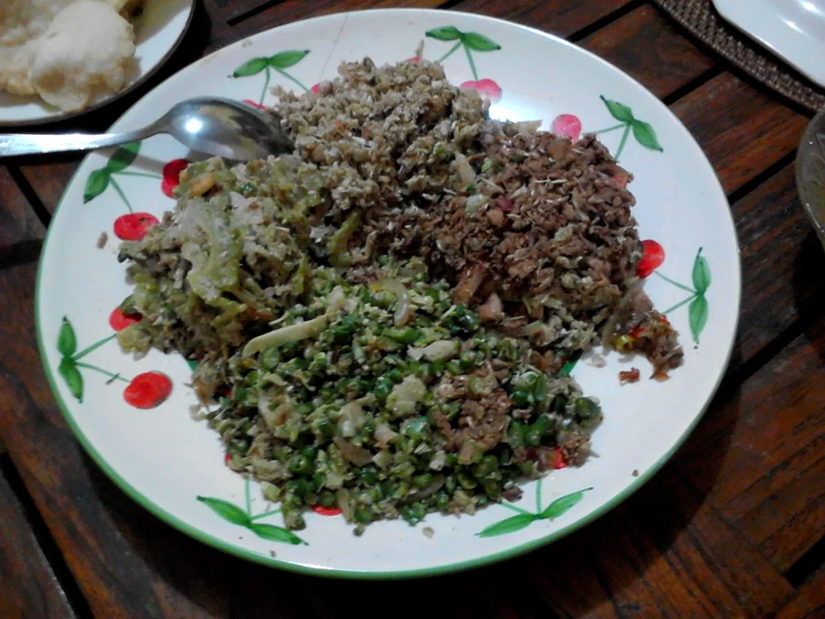 Plate of lawar: chopped vegetables, grated coconut and spiced meat