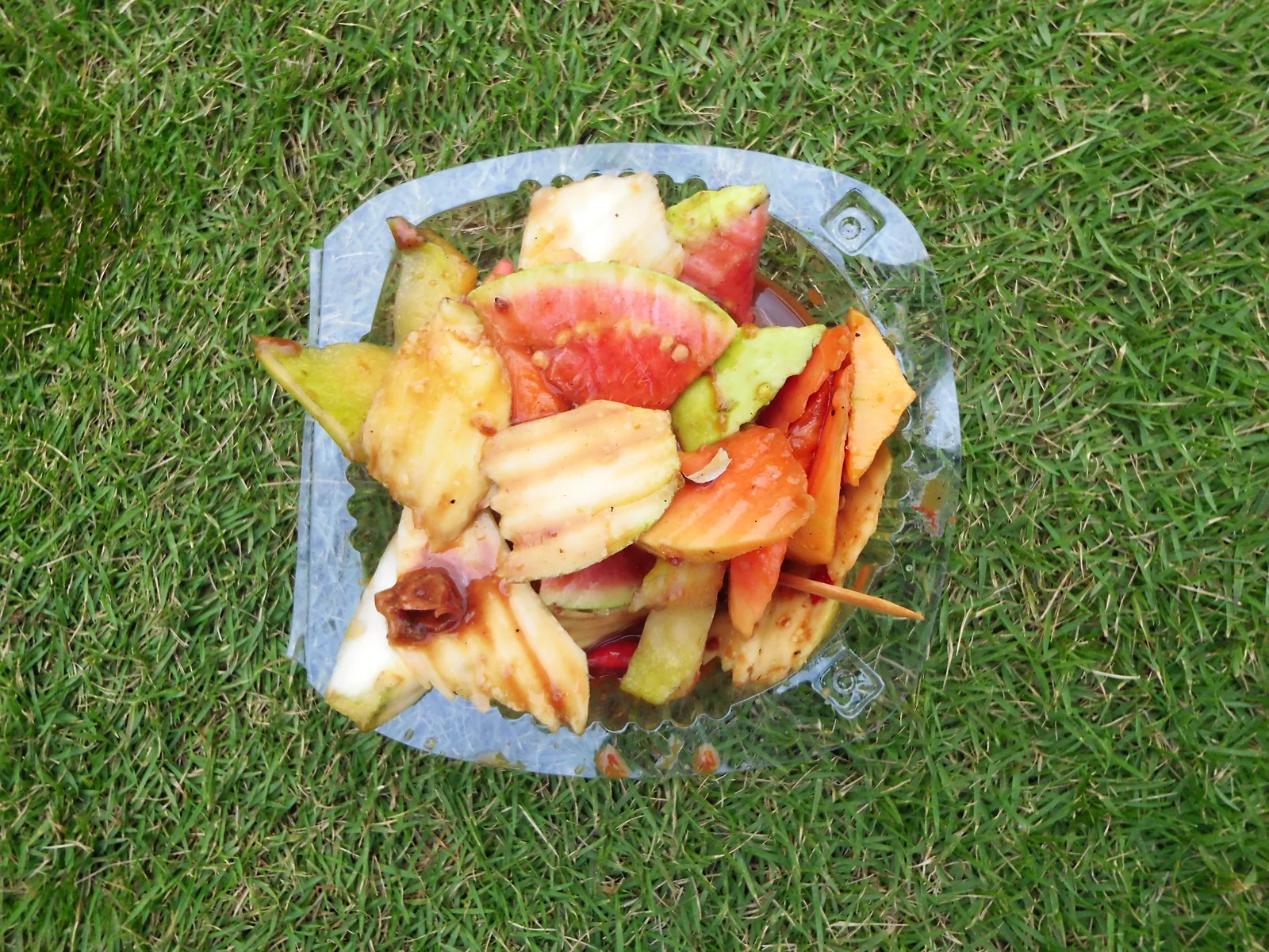 Tray of rujak: green mango, papaya and guava pieces in palm sugar and chilli sauce